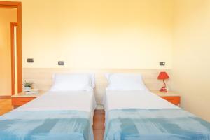 two beds sitting next to each other in a room at Residence Il Triangolo in Roseto degli Abruzzi