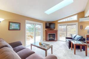a living room with a couch and a fireplace at Moon Swept on Keuka in Hammondsport