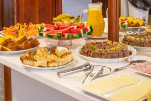 ein Buffet mit vielen verschiedenen Speisen auf dem Tisch in der Unterkunft Blumenau Tower by Castelo Itaipava in Blumenau
