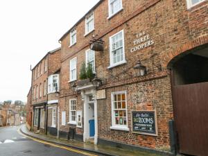 a brick building with a sign on the side of it at Firkin Cottage in Bedale