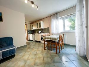 a kitchen and dining room with a table and chairs at M&aacute;ria-lak Zalakaros in Zalakaros