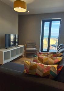 a living room with a bed and a tv and a window at Margate Seaside Haven With 2 Terraces Sleeps 6 in Kent
