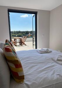 a bedroom with a bed with a view of a patio at Margate Seaside Haven With 2 Terraces Sleeps 6 in Kent
