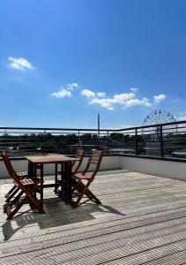 a table and chairs on a deck with a view at Margate Seaside Haven With 2 Terraces Sleeps 6 in Kent