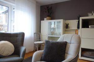 a living room with two chairs and a couch at Ferienhaus Hinterlandswald in Schlangenbad