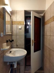 a bathroom with a white sink and a mirror at Hotel Cade in Písek