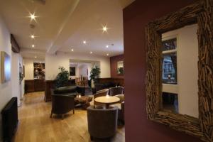 a mirror on the wall of a living room at Aberdunant Hall in Porthmadog