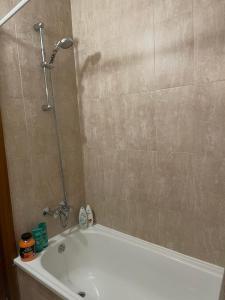 a bathroom with a shower and a white bath tub at Kate's apartment in Pirin in Razlog