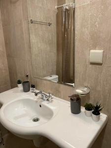 a bathroom with a sink and a mirror at Kate's apartment in Pirin in Razlog