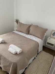 a bedroom with a large bed with two towels on it at Departamento para 2 personas in Rosario
