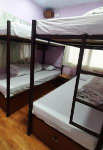 a couple of bunk beds in a room at Margik Backpackers Hostel in Pokhara