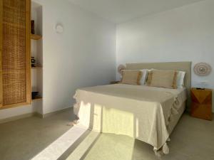 a bedroom with a bed in a white room at Calistus Mykonos in Mikonos