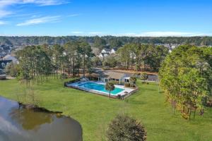 an aerial view of a home with a swimming pool in a yard at Coastal Getaway Less Than 1 Mi to Old Town Bluffton! in Bluffton