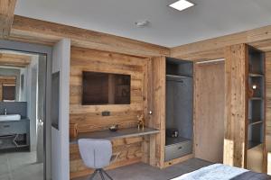 Televiisor ja/või meelelahutuskeskus majutusasutuses Sieglhub Chalets - Appartements - Hotel