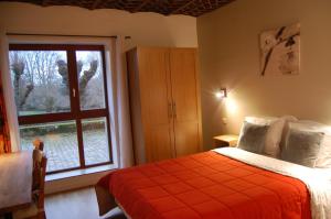 a bedroom with a bed and a large window at Gîte dans un Domaine Historique in Chevreuse