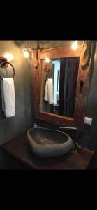 uma casa de banho com um grande lavatório de pedra e um espelho. em Sani Villa Haven em Sani Beach