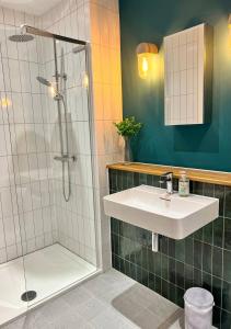 a bathroom with a shower and a sink at Margate Beach Front Apt With Sea Views Sleeps 6 in Kent