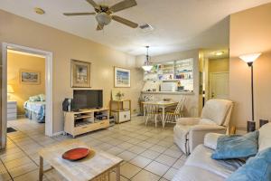 a living room with a couch and a tv at Ft Lauderdale Area Condo - Walk to Beach and Shops! in Fort Lauderdale