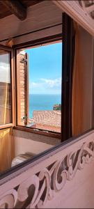 a window with a view of the ocean at La Villa Tanca Piras in Nebida