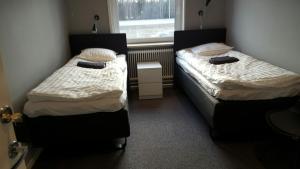 2 camas en una habitación pequeña con ventana en Motell Trafikanten en Bygdeå