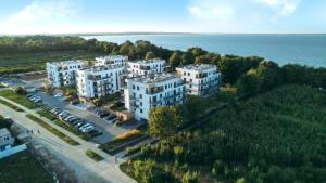 an aerial view of white buildings next to the water at Piękny Puck Apartamenty z tarasami in Puck
