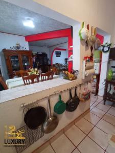 a kitchen with a counter with utensils on it at Home Sweet Home Guanajuato in Guanajuato