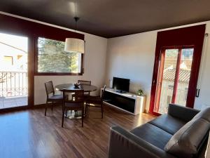 a living room with a couch and a table at Can Morera Apartaments a Les Preses in Les Preses