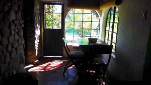 a room with a table and a window and a desk at Cabaña Hannah in San Marcos Sierras +9 photos
