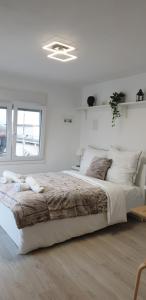a white bedroom with a large bed and a window at Skyview Studio in Kerkíni