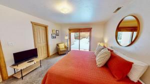 a bedroom with a bed and a mirror and a television at The Rock #3461 in Moab