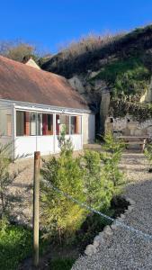 uma casa com uma cerca em frente em Le Troglo'Gîte, 500m à pied du Zoo de Beauval em Seigy