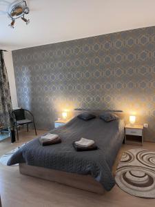 a bedroom with a large bed with two lights on it at FAI Avantgarden Retreat in Braşov