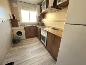 A kitchen or kitchenette at ACV- Costa Marfil II-2ª linea planta 6 frontal