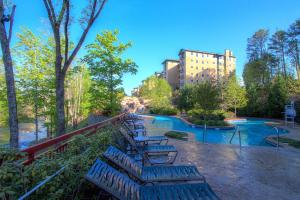 a row of benches in a park with a pool at RiverStone Condo Resort & Spa in Pigeon Forge