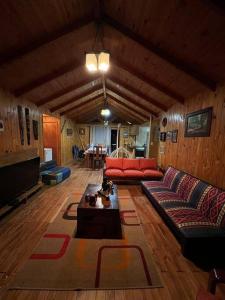 a living room with a couch and a table at Parcela de agrado orilla de lago in El Estero