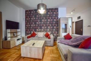 a living room with a couch and a table at Ambasador Zlatibor in Zlatibor