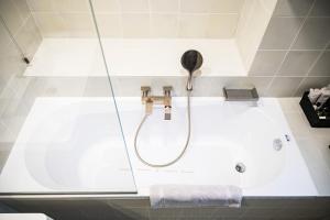 a bathroom with a shower and a bath tub at Villa Prato in Braşov