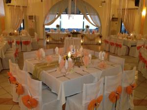 a banquet hall with white tables and white chairs at Faros Luxury Suites in Marathopolis