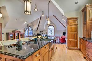 a large kitchen with wooden cabinets and a large island at Historic Guest House on Castle Kimble Estate! in Manhattan