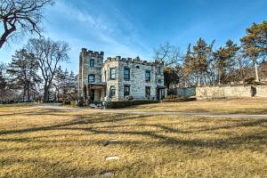 an old stone house on a grassy field at Historic Guest House on Castle Kimble Estate! in Manhattan