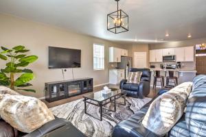 a living room with two couches and a tv at Spacious Aurora House with Yard about 10 Mi to DIA! in Aurora