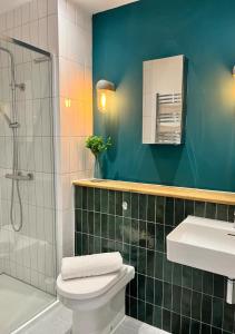 a bathroom with a toilet and a sink and a shower at Margate Main Sands Sea views Central Location Sleeps 4 in Kent +22 photos