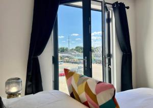 a bedroom with a window with a view of a stadium at Margate Main Sands Sea views Central Location Sleeps 4 in Kent