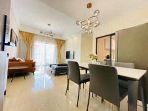 a dining room and living room with a table and chairs at GolfHill Apartment in Kigali