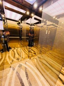 a bathroom with a shower with a glass wall at GolfHill Apartment in Kigali +12 photos