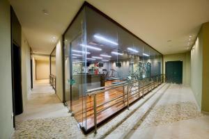 a hallway with a glass wall in a house at Sani Polyastron Hotel & Spa in Sani Beach