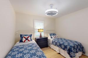 a bedroom with two beds and a window at Coastal Dream - 2232 Ocean Rd in Saint Simons Island