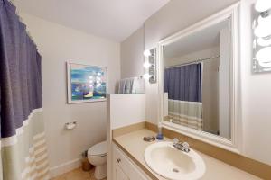 a bathroom with a sink and a toilet at Coastal Dream - 2232 Ocean Rd in Saint Simons Island +16 photos