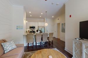 a living room and kitchen with a couch and a table at King Suite @ 400 Ocean Suites in King City +3 photos