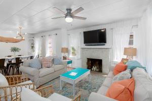 a living room with a couch and a fireplace at Waterside - 829 Park Way in Saint Simons